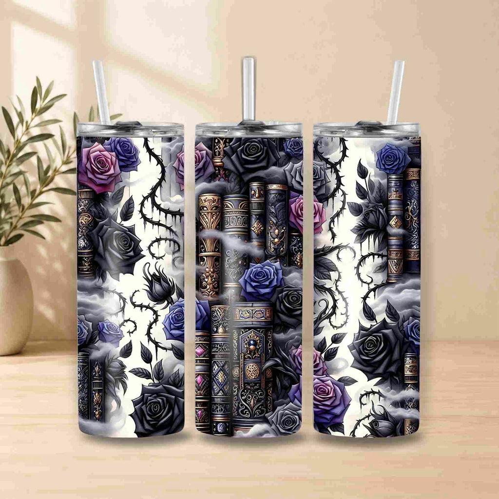 Three Dark Book Lover 20oz Skinny Tumblers from Becca's Banging Designs LLC, featuring vintage books, purple and black roses, and swirling vines, make a stunning book lover display with straws and a blurred plant in the background.