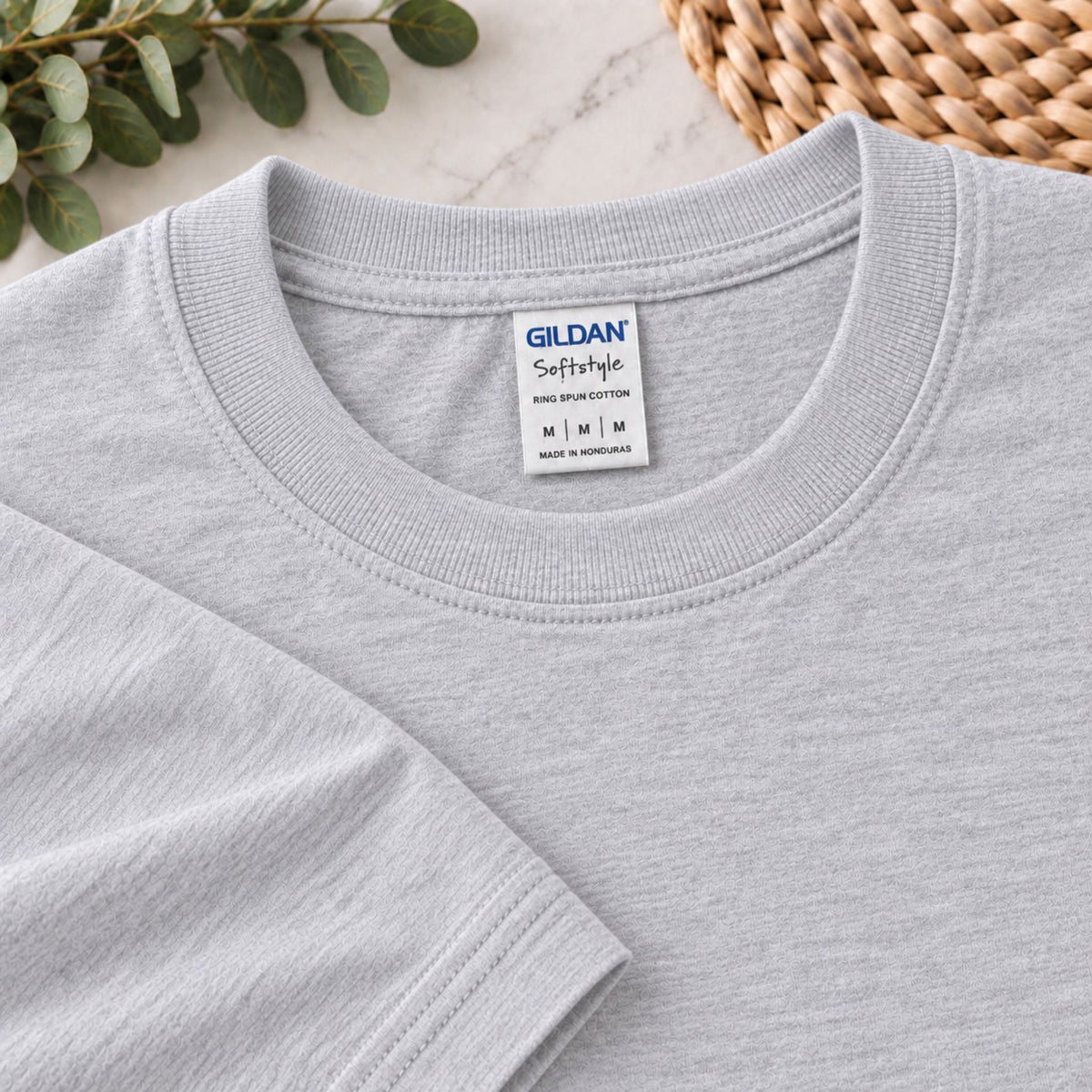 Heather gray T-shirt close-up showing Gildan Softstyle neck label