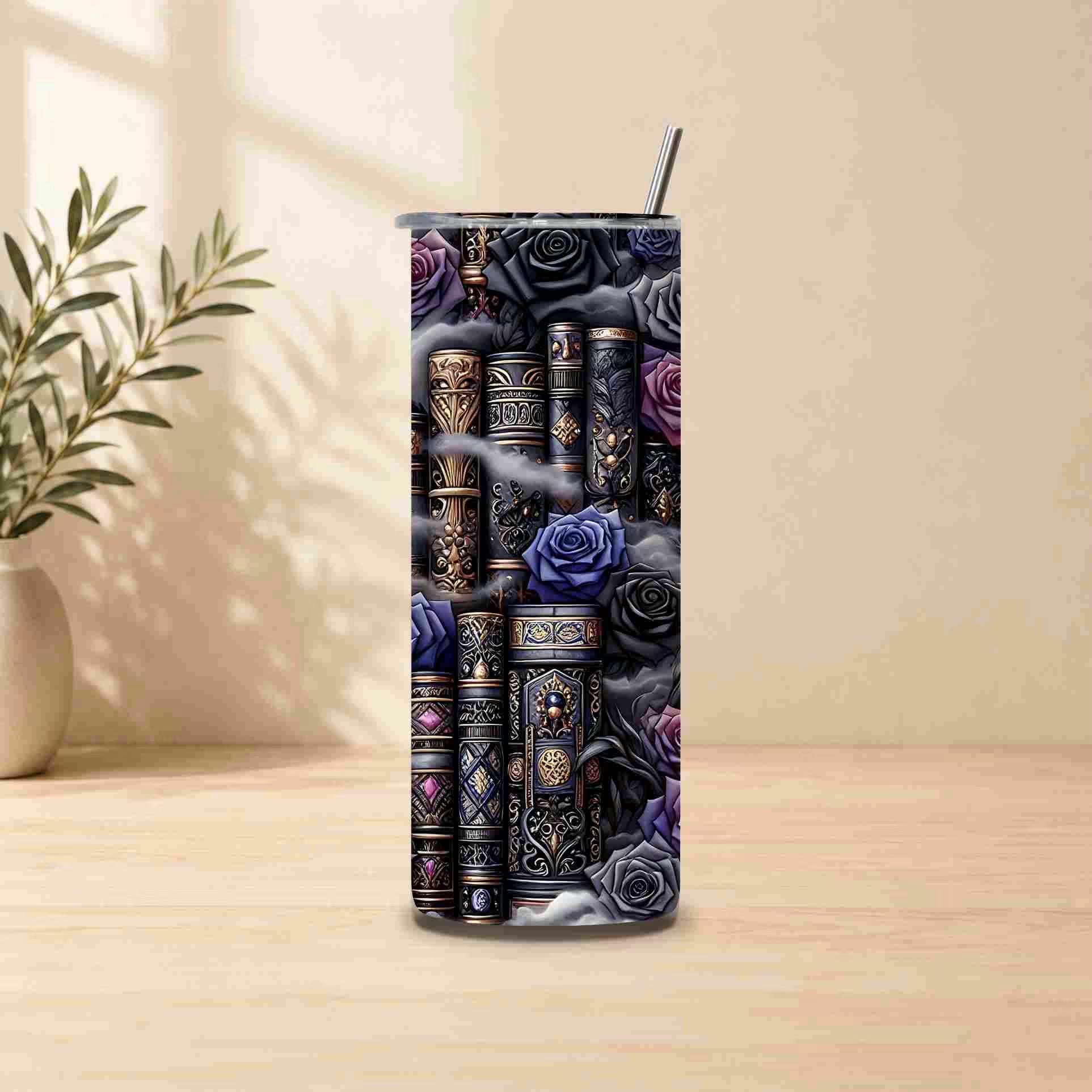 The Dark Book Lover 20oz Skinny Tumbler by Becca's Banging Designs LLC features ornate books and purple-black roses, comes with a metal straw, and sits on a wooden surface near a potted plant in soft light.