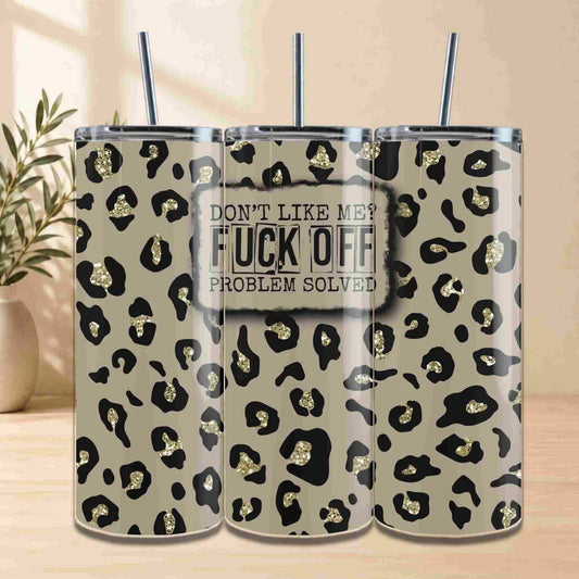 Three Leopard Print | 20oz Tumblers with straws show a bold gold and black leopard pattern; the center reads: DONT LIKE ME? FUCK OFF. PROBLEM SOLVED. A leafy plant decorates the background.