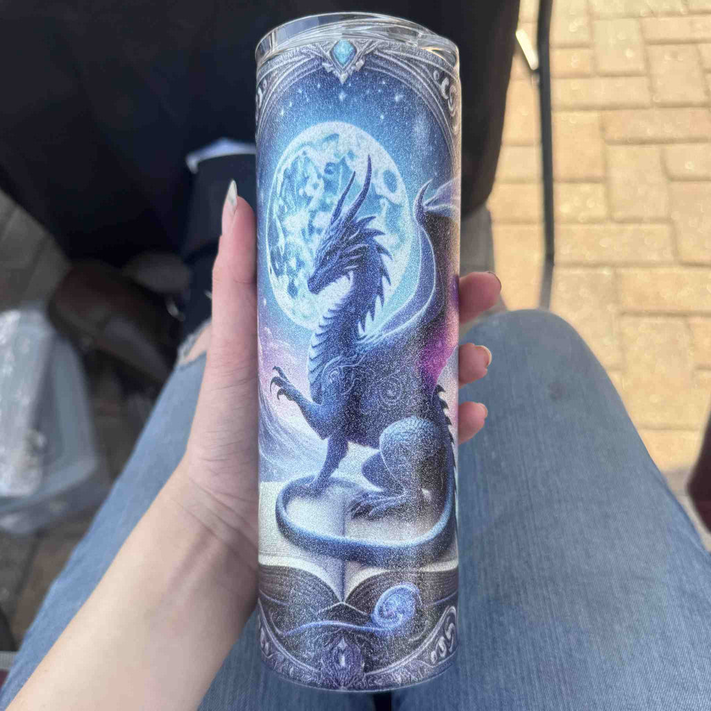 Tumbler with dragon design held by a person outdoors