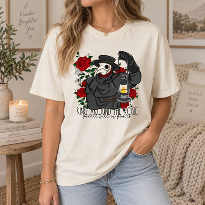 Cream graphic tee with plague doctor and red roses lantern print, worn with jeans