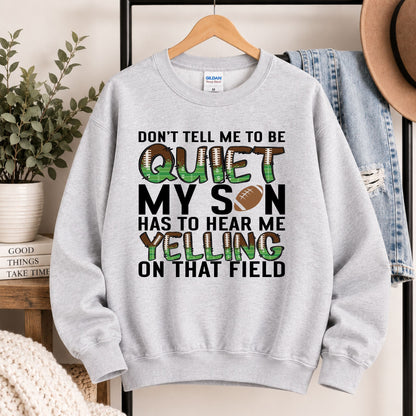 Grey crewneck sweatshirt hanging on a rack with large "QUIET" football slogan artwork