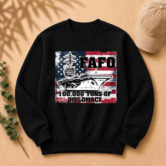 Black sweatshirt with a graphic design featuring an American flag and text on a beige background.