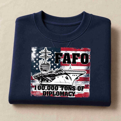 Folded navy blue sweatshirt with graphic design and text on a beige background