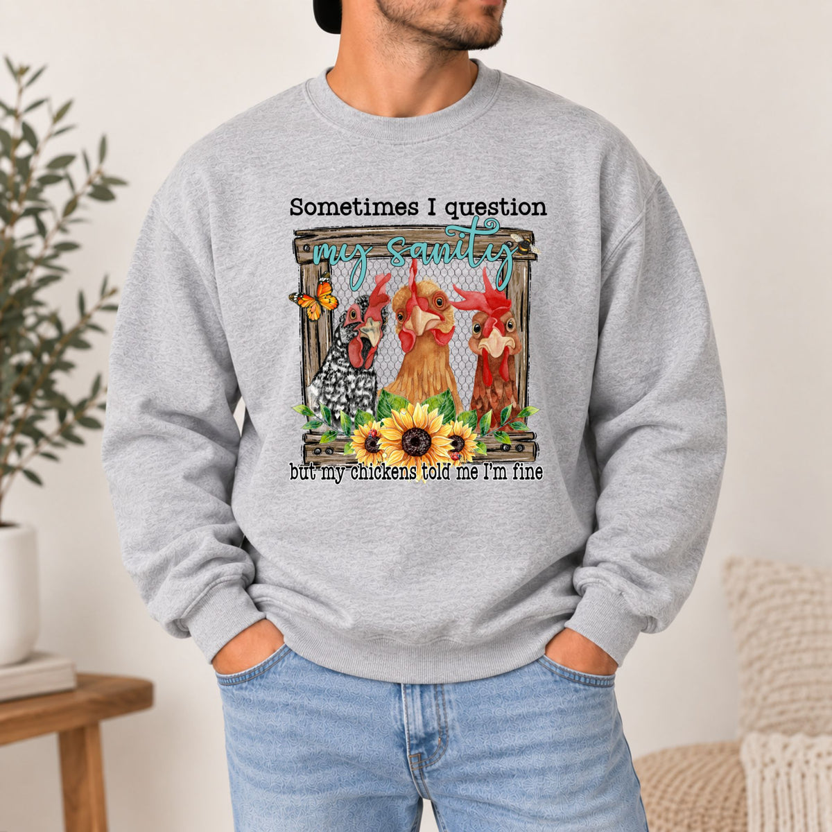 Grey crewneck sweatshirt on model with front chicken graphic and quote text at chest.