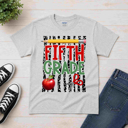 Gray t-shirt with 'Fifth Grade' design on a wooden surface with shoes and jeans.