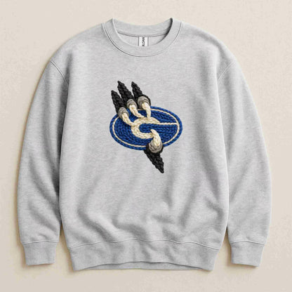 The Gateway Griffins | Crewneck by Becca's Banging Designs is a cozy, oversized light gray sweatshirt featuring a central embroidered patch with a blue oval, beige rope accent, and three black spikes on the left.