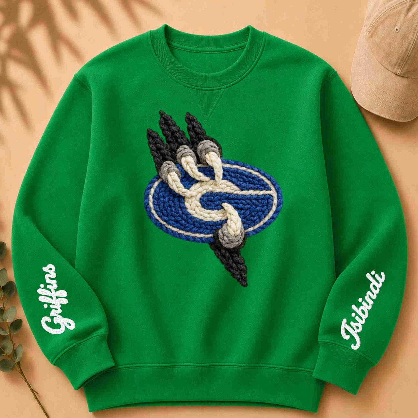 Green sweatshirt with yarn-like design and text on a beige background