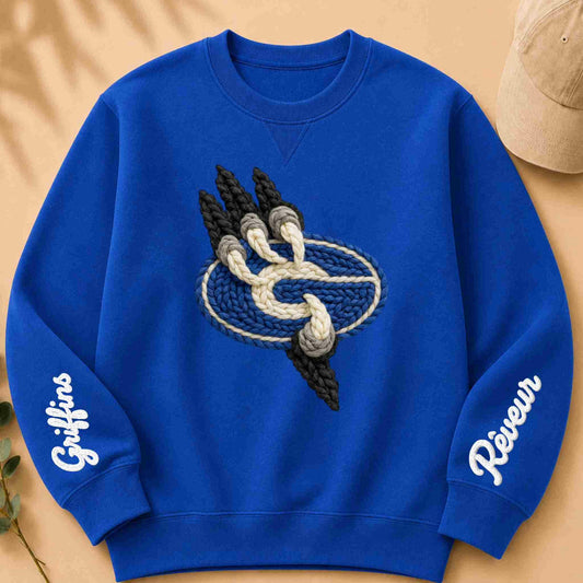 Blue sweatshirt with yarn-like design and text on a beige background