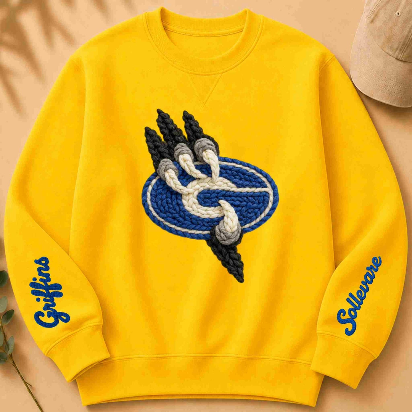 Yellow sweatshirt with a School logo and text on a beige background