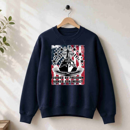 Navy blue sweatshirt with a graphic design on a hanger against a white wall.