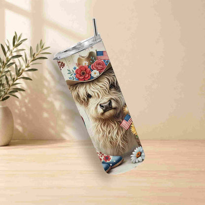Tumbler with a llama design featuring flowers and American flags on a wooden surface.