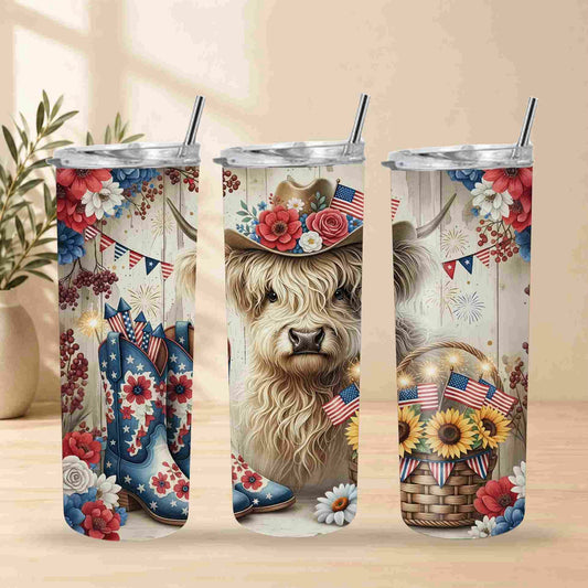 Three stainless steel tumblers with a decorative design featuring a cow, flowers, and American flags on a wooden surface.