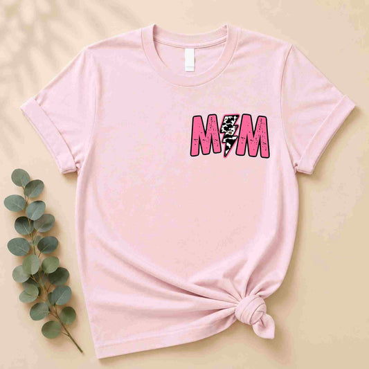 The Hot Mom Summer Tee – Trendy Mama Graphic Shirt by Becca's Banging Designs LLC is a light pink women's tee featuring a bold M💥M design with a lightning bolt for the O, styled with a side knot—perfect for warm days.