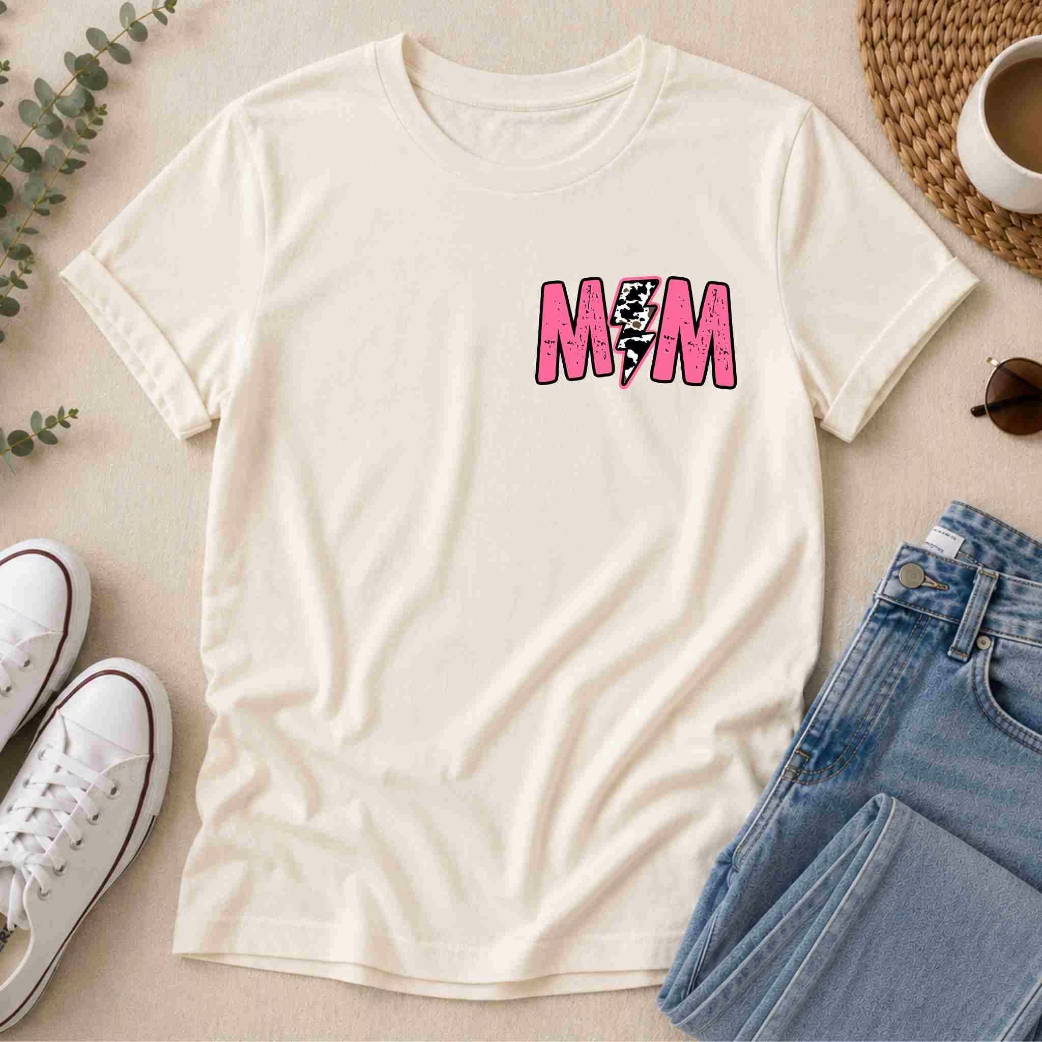 The Hot Mom Summer Tee – Trendy Mama Graphic Shirt by Becca's Banging Designs LLC features cream fabric with bold pink M/M and a lightning bolt—perfect styled with jeans, shoes, and shades for your Hot Mom Summer wardrobe.