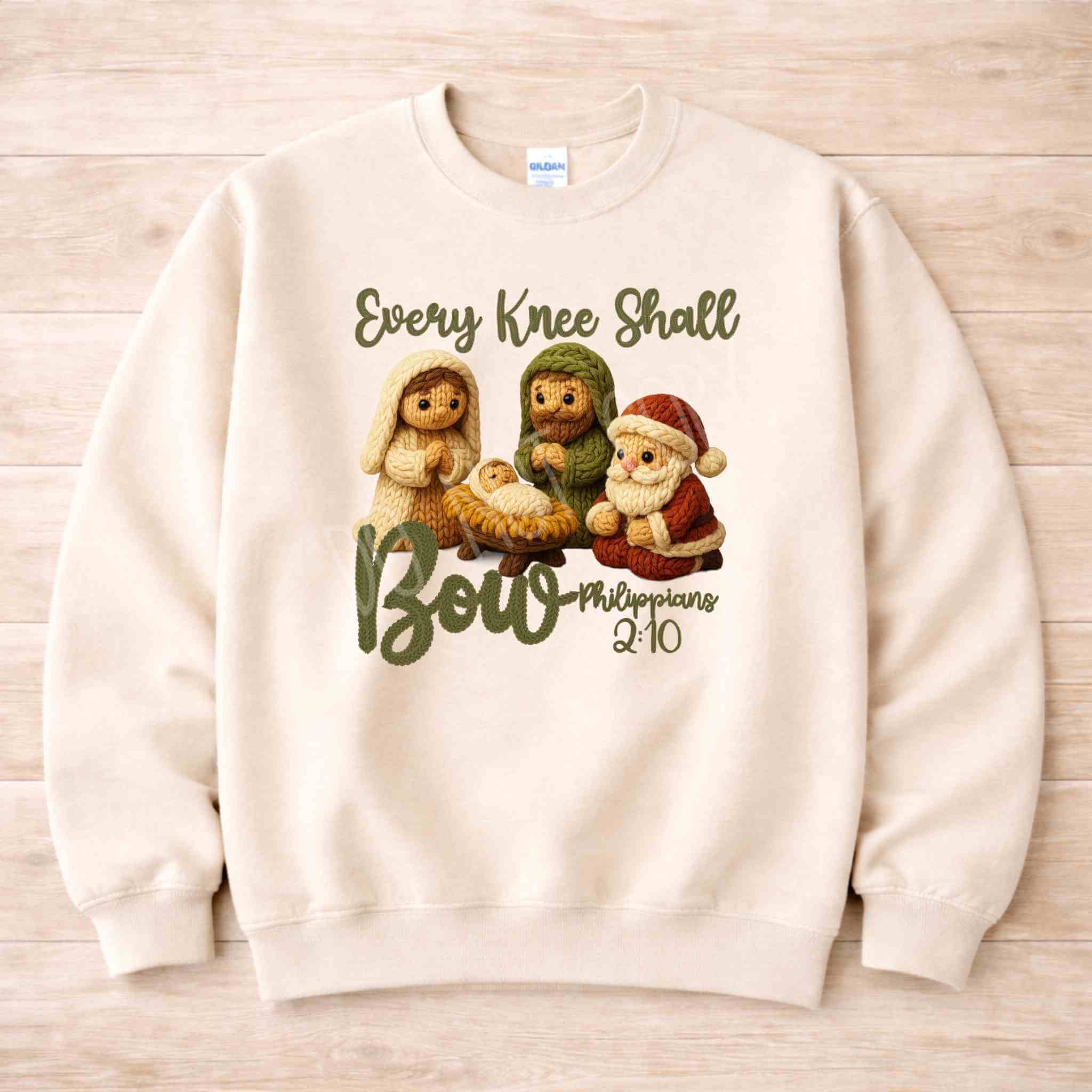 Every Knee Shall Bow Christmas Sweatshirt featuring nativity scene design with soft colors.