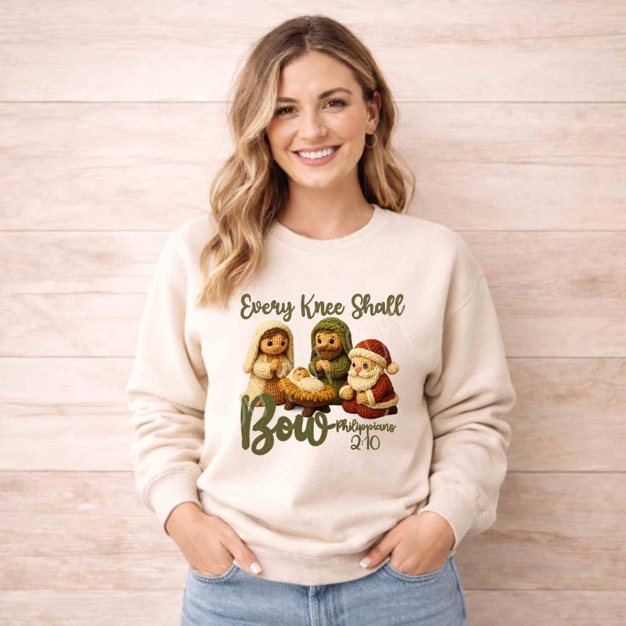 Every Knee Shall Bow Christmas Sweatshirt featuring festive characters and inspirational design.