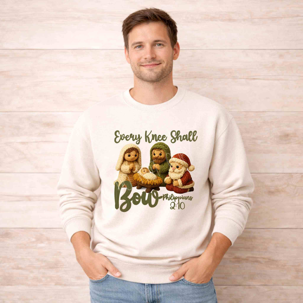 Man wearing Every Knee Shall Bow Christmas Sweatshirt featuring nativity scene design.