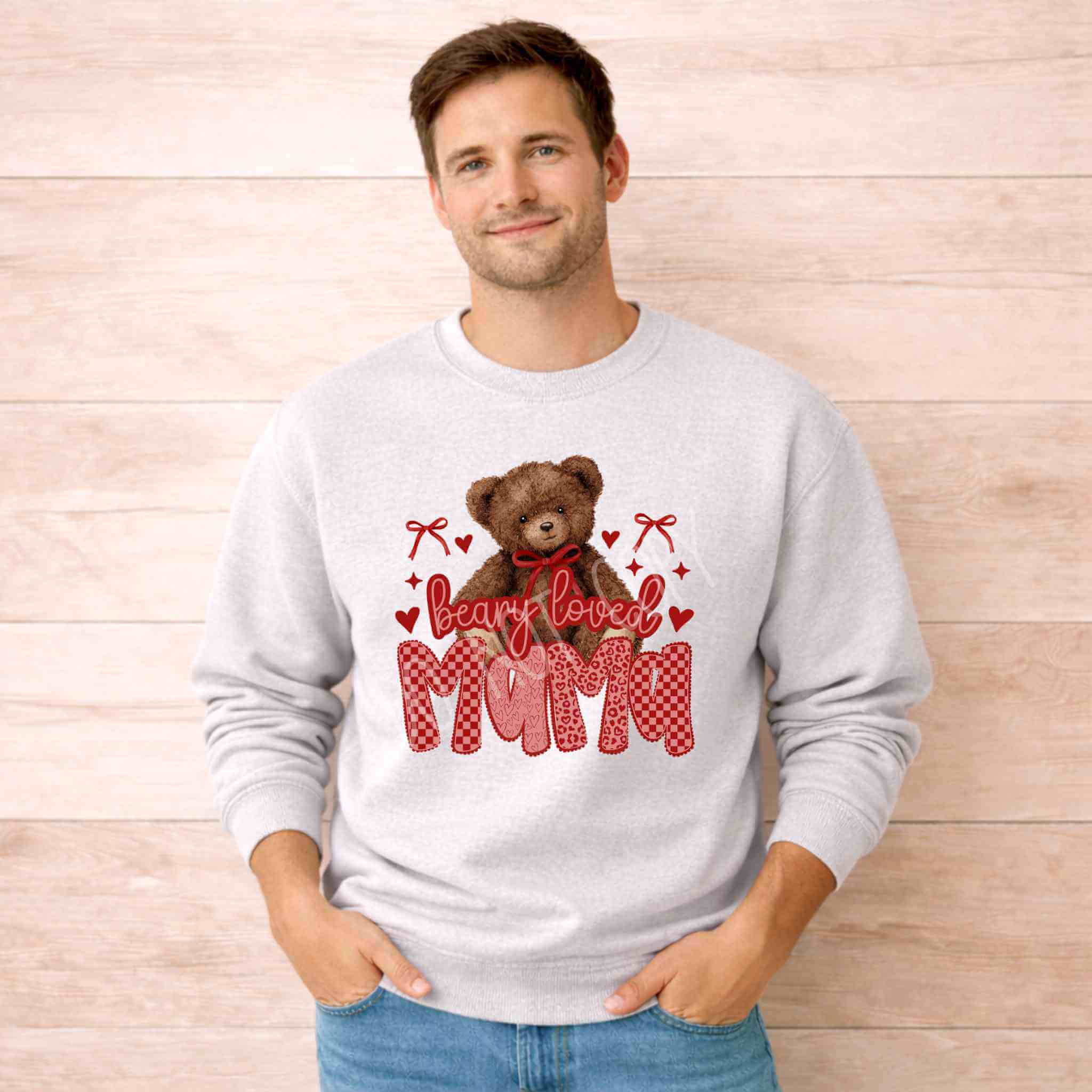 Beary Loved Mama Sweatshirt Comfort Style and Care featuring teddy bear and heart design worn by a man.