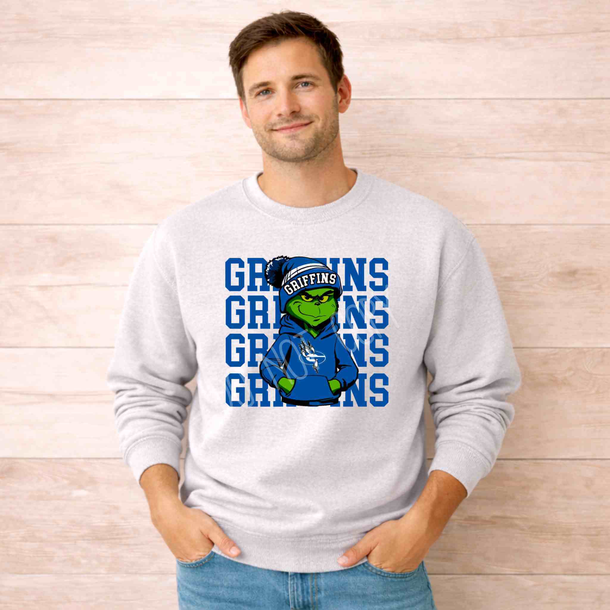 Griffins Crewneck Sweatshirt Youth Comfort and Style worn by a smiling man, featuring a griffin graphic on a gray background.