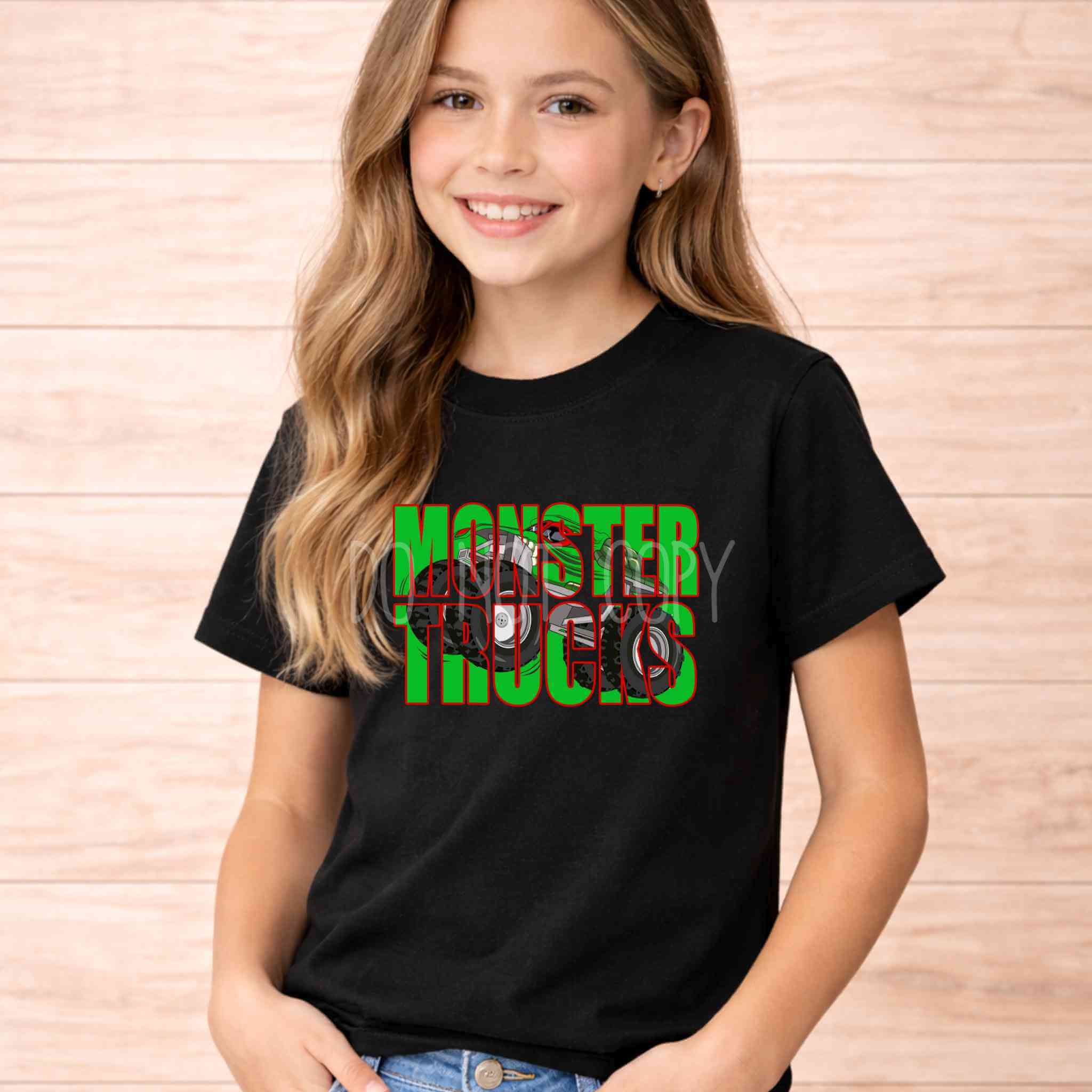 Monster Trucks Youth T Shirt Kids Graphic Tee featuring a girl wearing a black shirt with vibrant monster truck design.