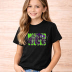 Monster Trucks Youth T Shirt Neon Green Purple Graphic Tee worn by a smiling girl in a black t-shirt