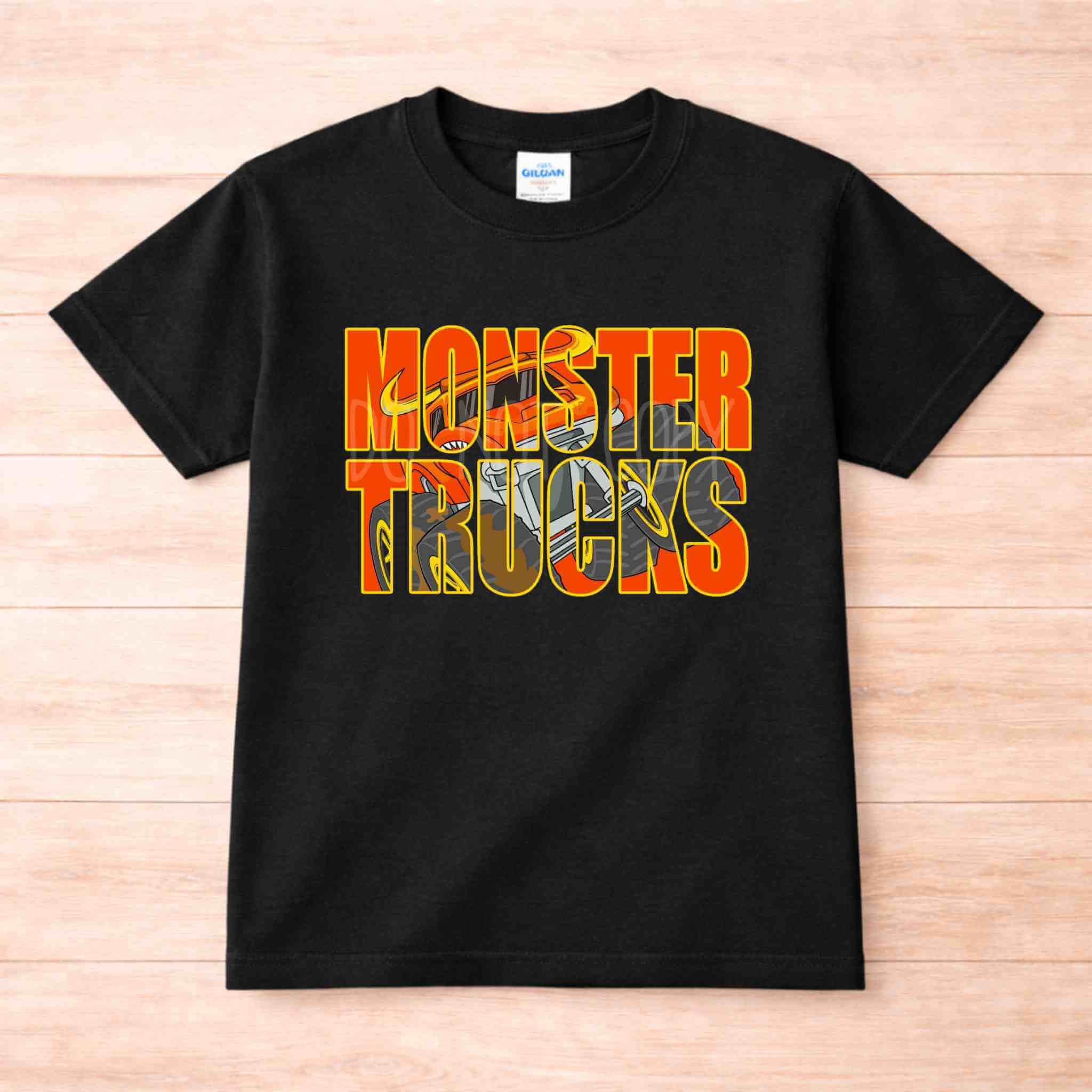 Monster Trucks Kids Shirt Youth Graphic Tee featuring bold orange and yellow design on a black t-shirt.
