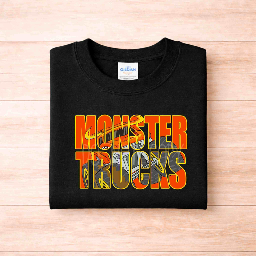 Monster Trucks Kids Shirt Youth Graphic Tee featuring bright orange and yellow graphic on a black t-shirt.