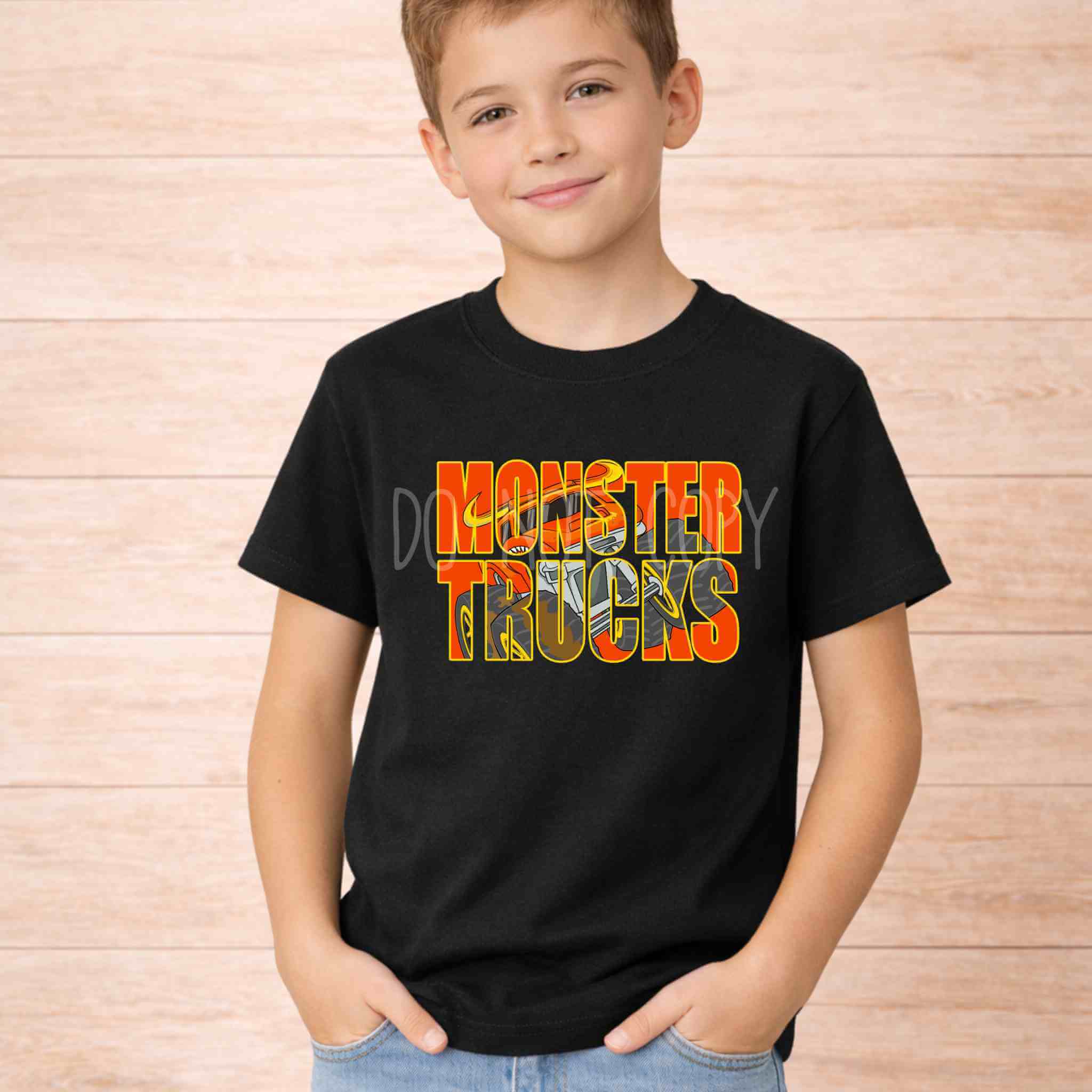 Monster Trucks Kids Shirt Youth Graphic Tee featuring a child wearing a black shirt with a vibrant orange and yellow graphic.
