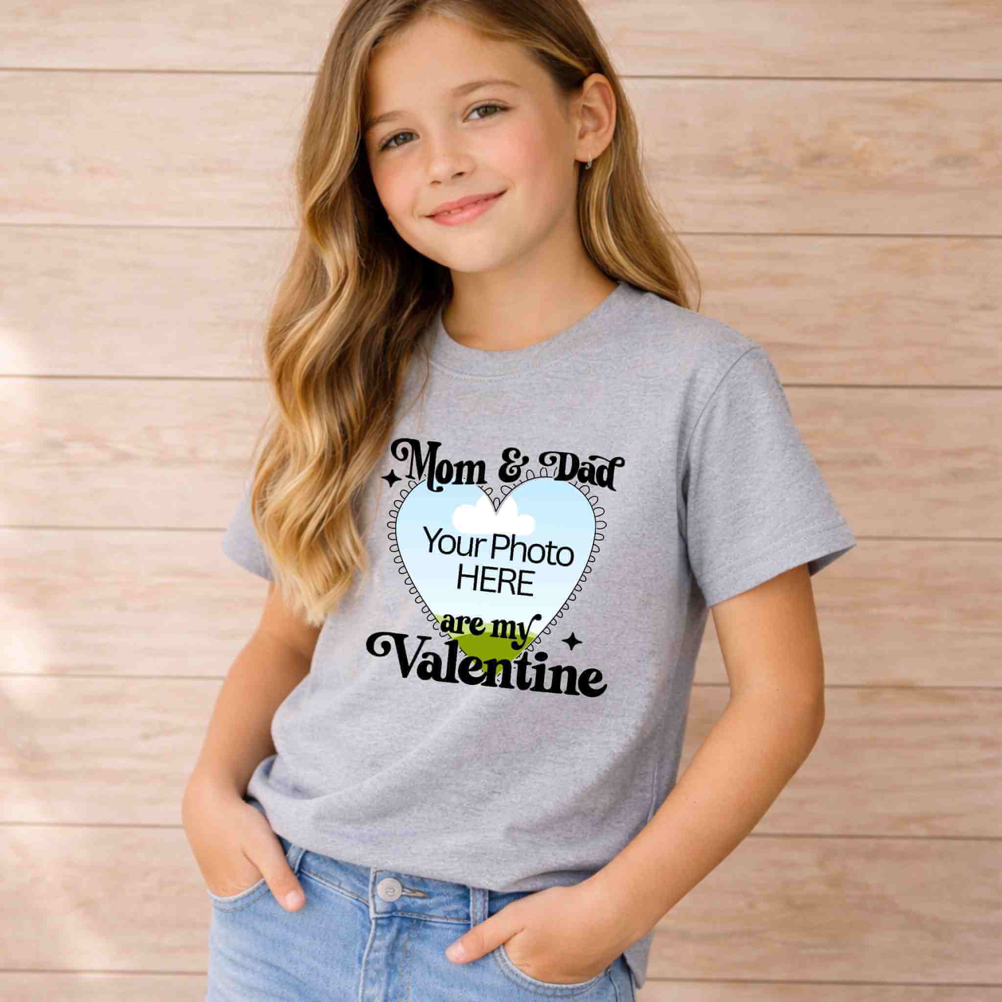 Mom And Dad Are My Valentines Kids T Shirt worn by a girl against a light background, featuring a customizable photo area.