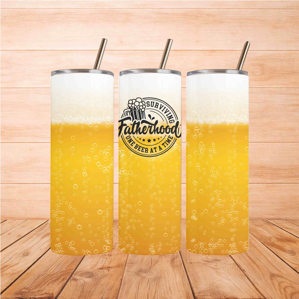 Dad Life Beer Tumbler with frothy beer design and straw on wooden background.