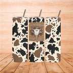 Three Cowgirl Tumblers - Cowgirls Don’t Cry 20oz with cow print design on wooden surface.