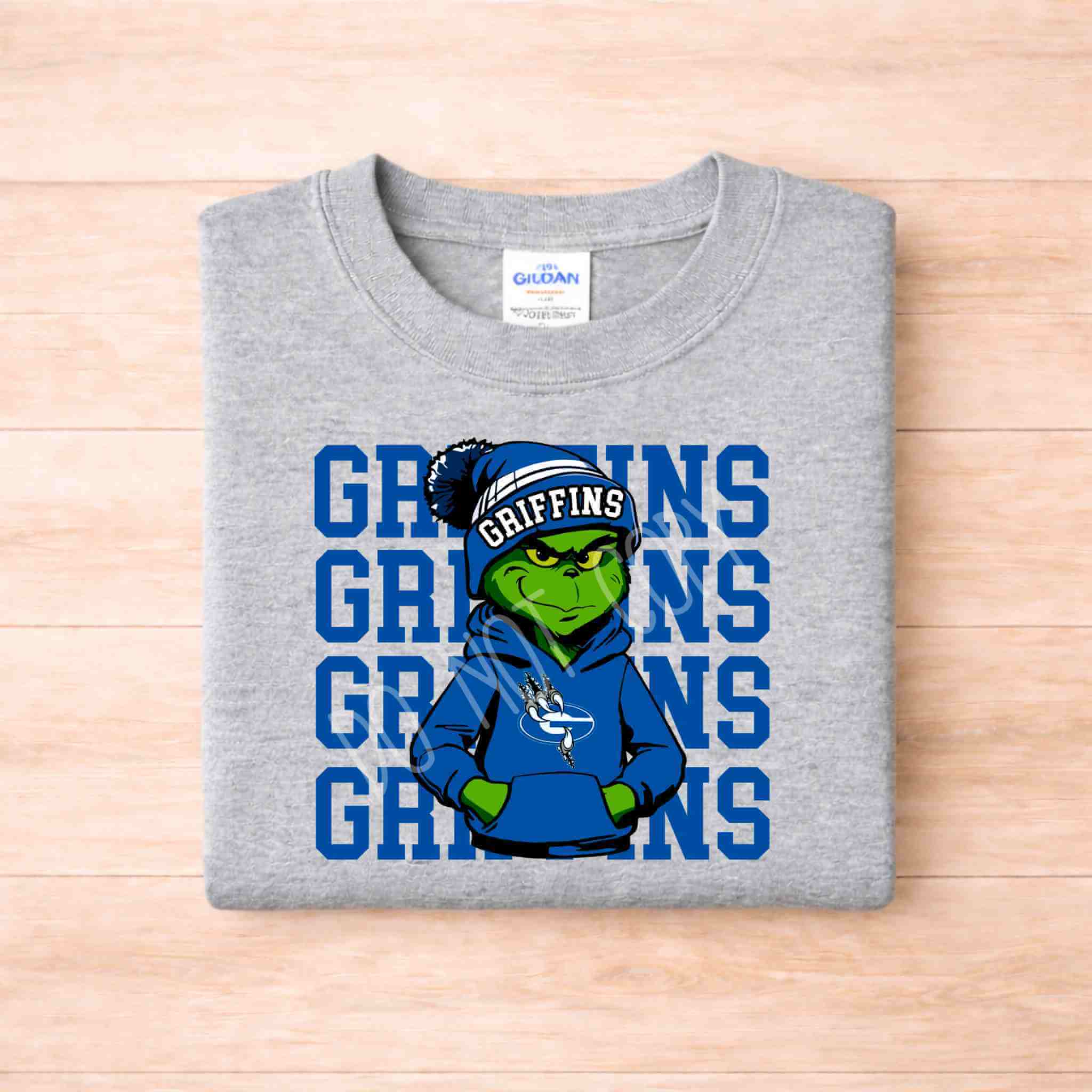 Griffins Graphic Tee Youth Comfort and School Spirit featuring a graphic design of a green character on a gray shirt.