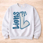 Lions School Spirit Sweatshirt featuring a varsity 'L' and a stylish bow, perfect for school pride and game days.
