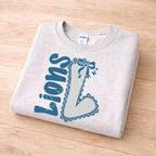 Lions School Spirit Sweatshirt with varsity L and bow detail, perfect for showing school pride in style.