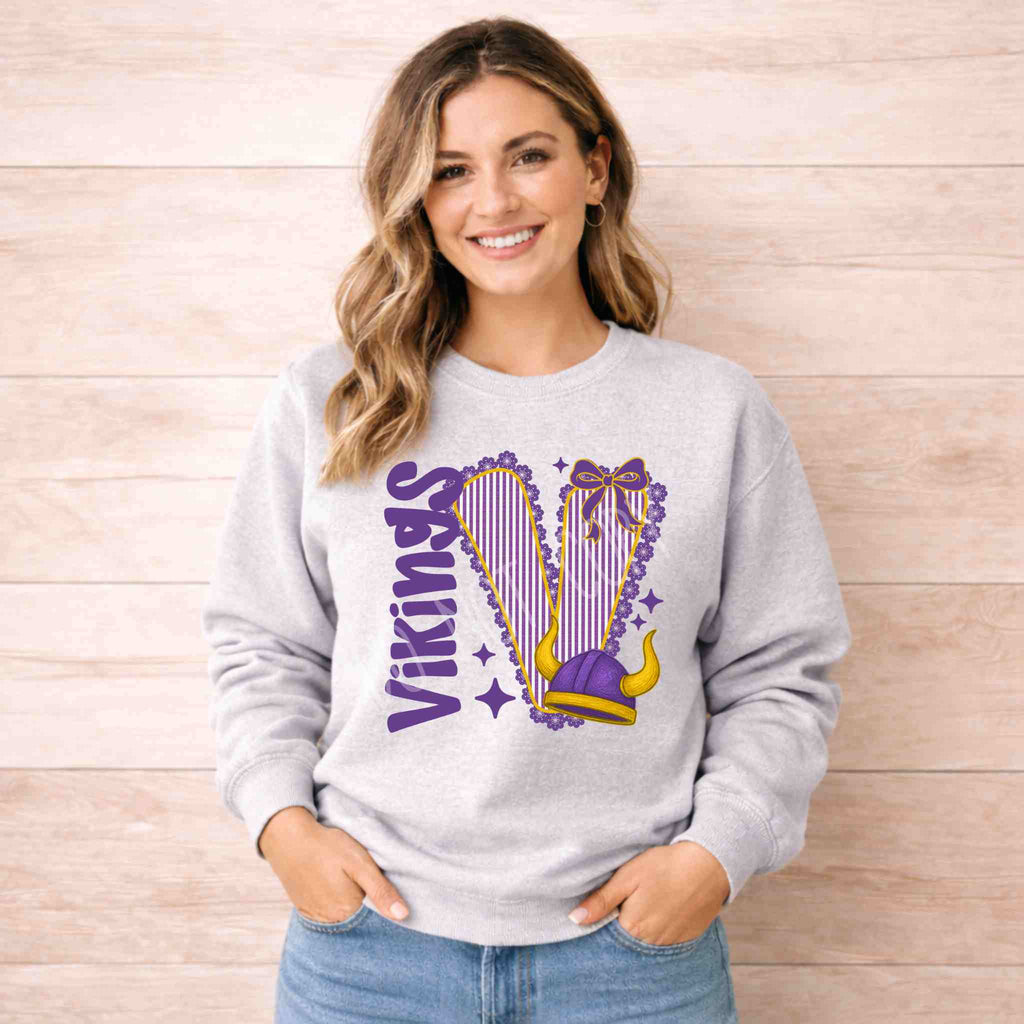 Vikings School Spirit Sweatshirt featuring a varsity graphic and bow accent on a light gray crewneck.