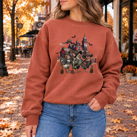 Rust-brown crewneck sweatshirt with witchy chicken graphic on the chest