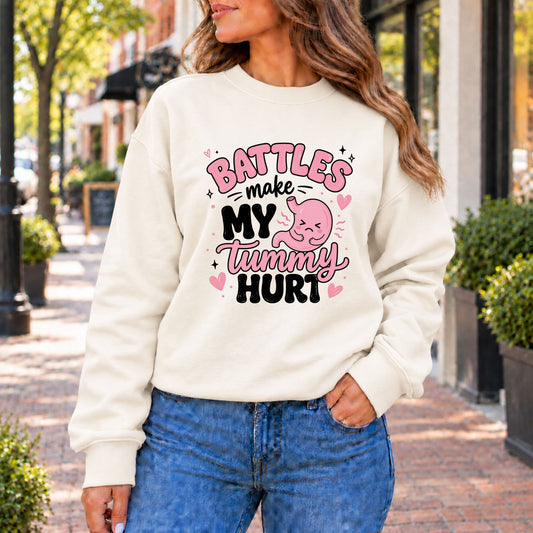 Ivory crewneck sweatshirt with colorful 'BATTLES make my tummy hurt' graphic