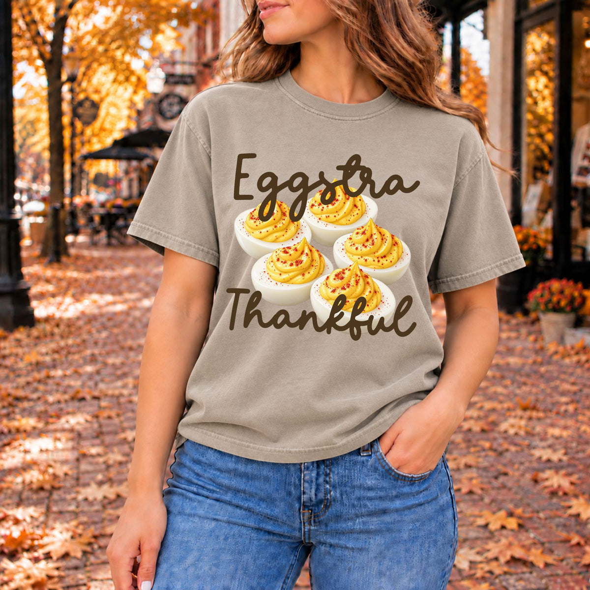 Warm gray graphic tee printed with five paprika-dusted deviled eggs and the words Eggstra Thankful.