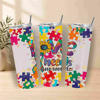 The Autism Awareness Love Needs No Words 20oz Tumbler by Becca's Banging Designs LLC features puzzle pieces and a sunflower—perfect for showing support or gifting as an autism support tumbler.