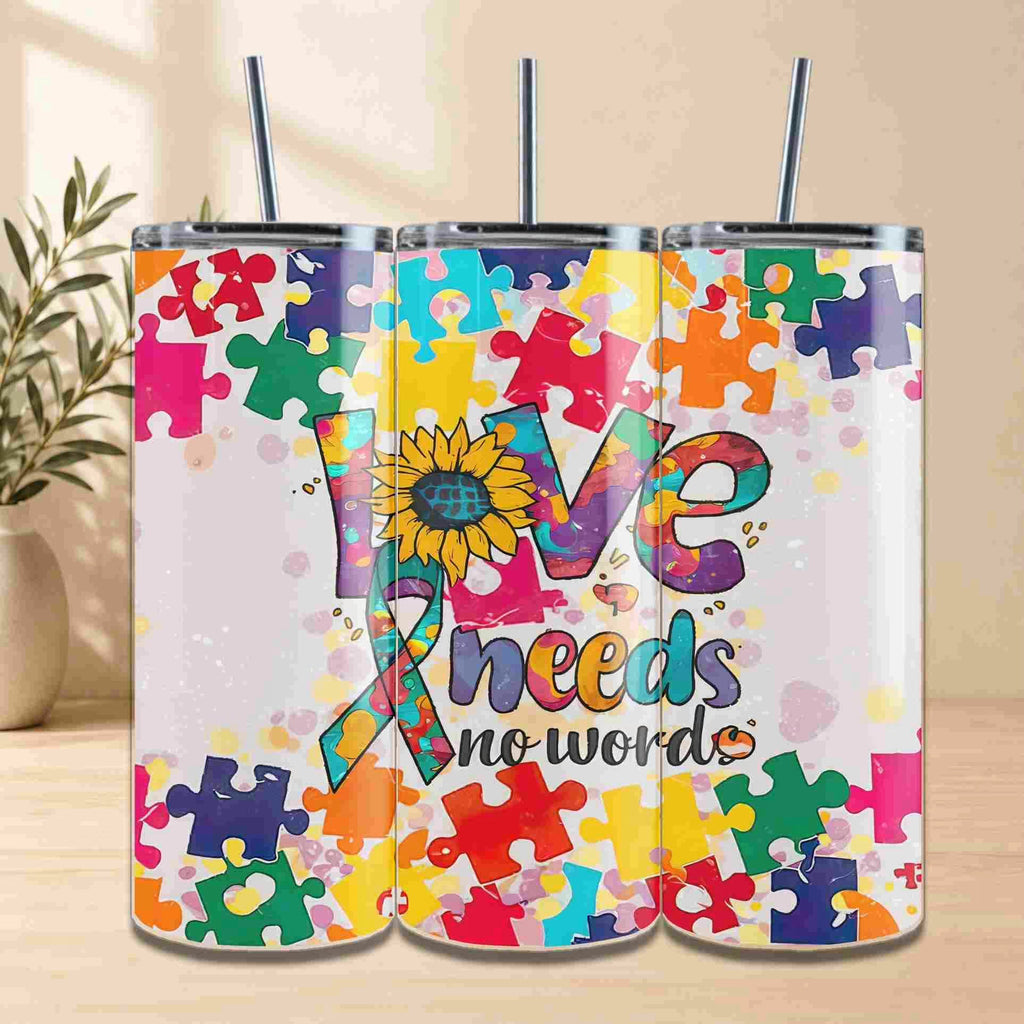 The Autism Awareness Love Needs No Words Tumbler – 20oz from Becca's Banging Designs LLC features a puzzle piece sunflower and ribbon, making it a meaningful gift for autism support or awareness.