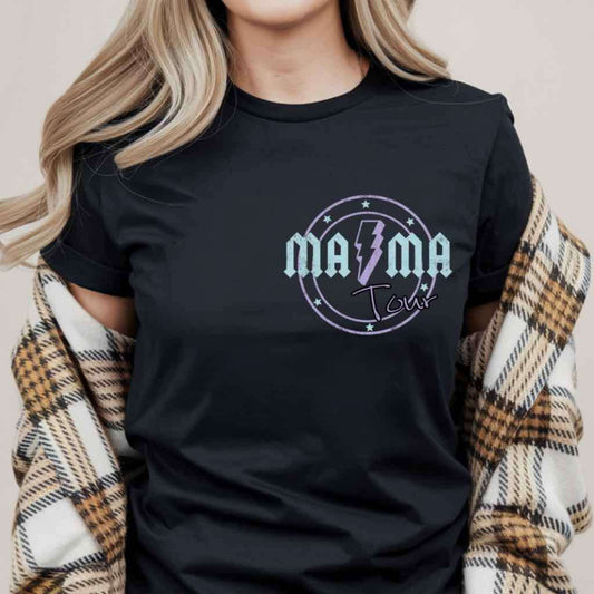 Person wearing a black t-shirt with 'ma ma tour' design, standing against a neutral background.