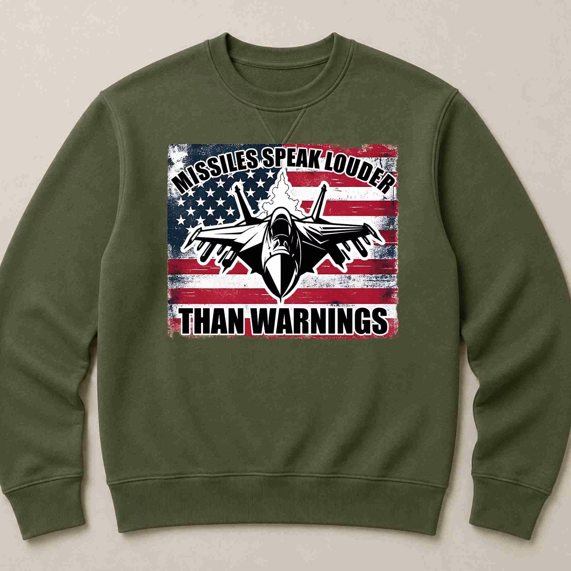 Green sweatshirt with American flag and fighter jet graphic on a beige background