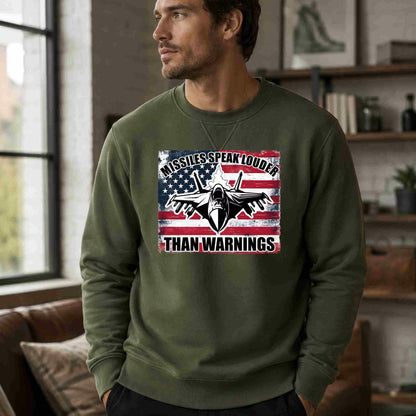 Man wearing a green sweatshirt with a graphic design and text in a room.