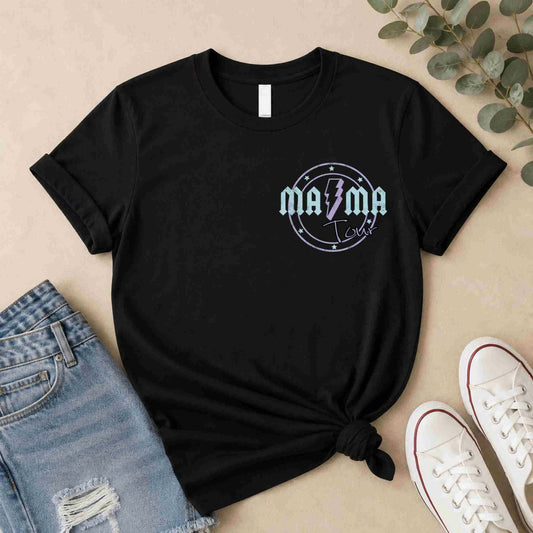 Black t-shirt with 'Mama' graphic design on a beige surface with jeans and sneakers.