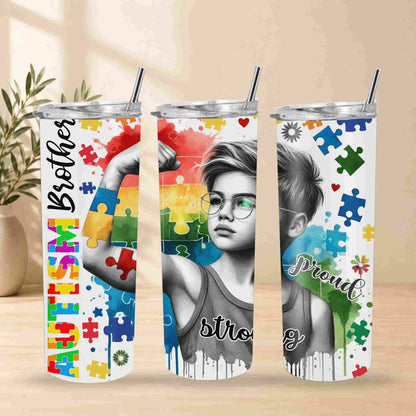 Three stainless steel tumblers with autism awareness designs on a wooden surface.