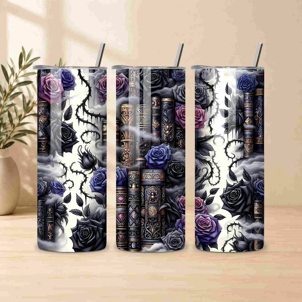 Becca's Banging Designs LLC Dark Book Lover 20oz Skinny Tumblers feature metal straws and gothic designs—dark books, black thorns, and purple-black roses—perfect for book lovers. Displayed on wood with a plant in the background.