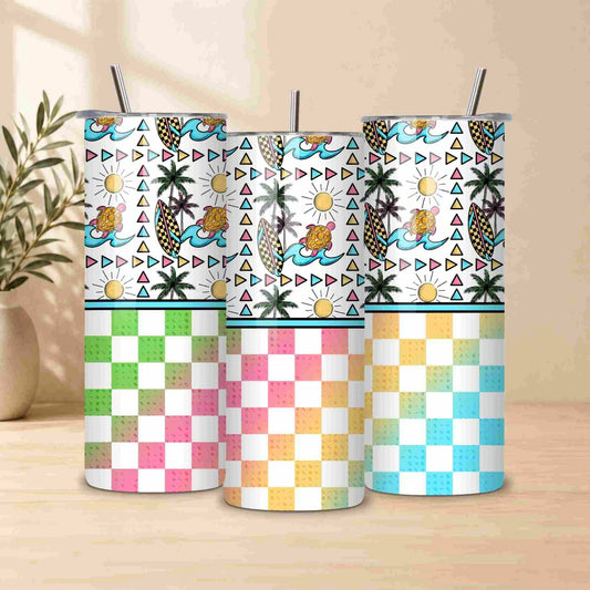 Set of four tumblers with tropical patterns on a wooden surface.