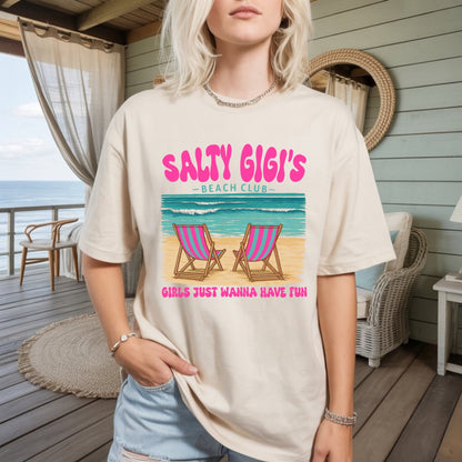 Women's beige graphic t-shirt with 'Salty Gigi's Beach Club' text and chair illustration